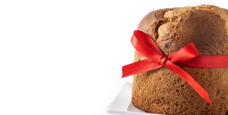 Traditional Christmas panettone with red tie isolated on white background