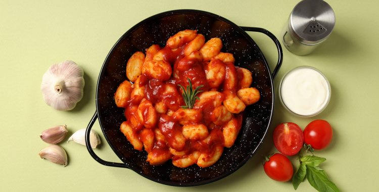 Concept of tasty food with potato gnocchi, top view
